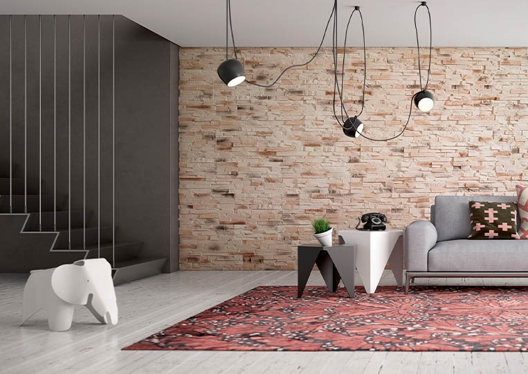 Salon moderne avec un pant de mur en pierre reconstituée acl caster sable